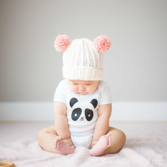 baby hat with two pom poms